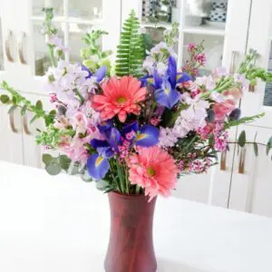 Square image of colorful floral valentines arrangement in red vase