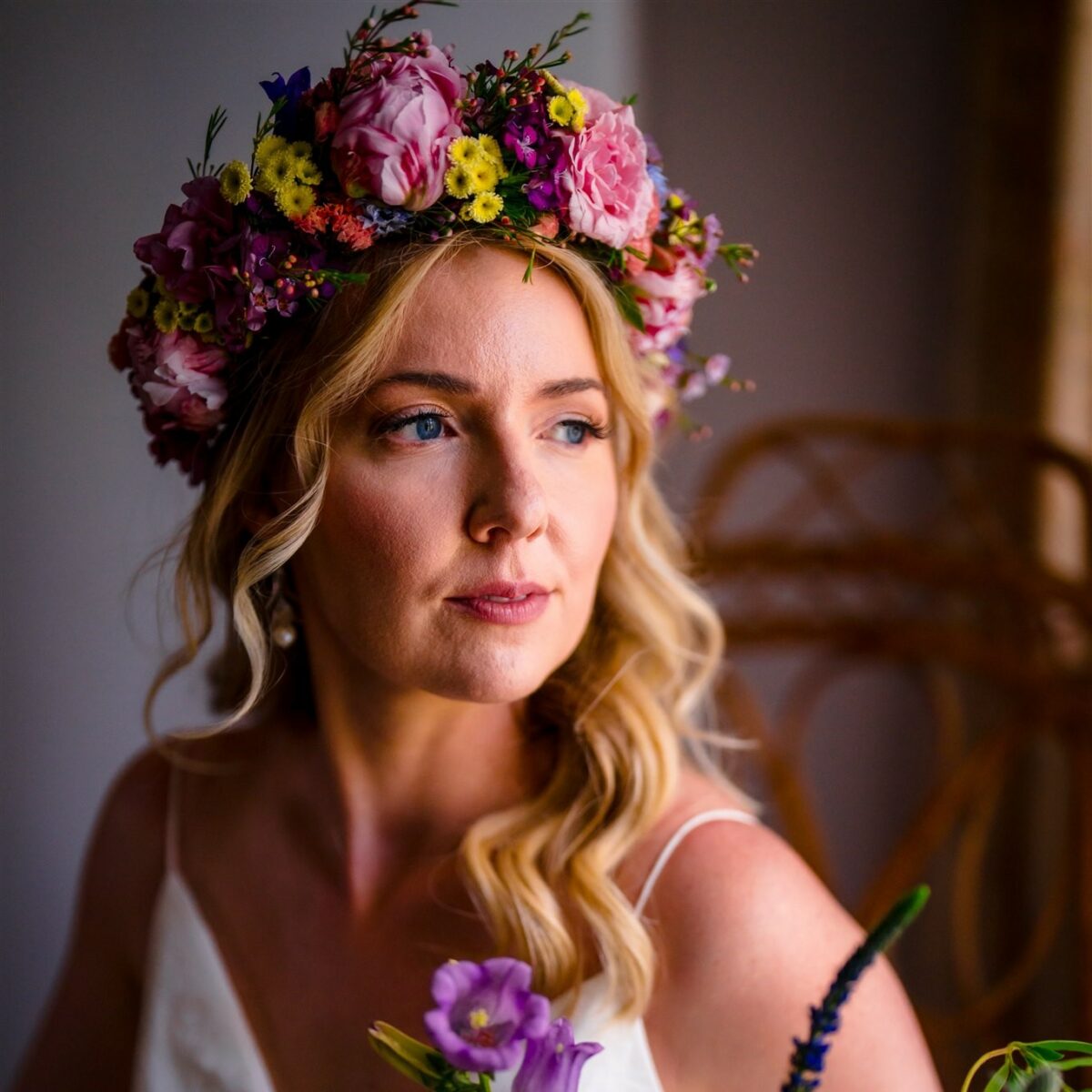 Bride wearing a flower crown in bright spring colors.