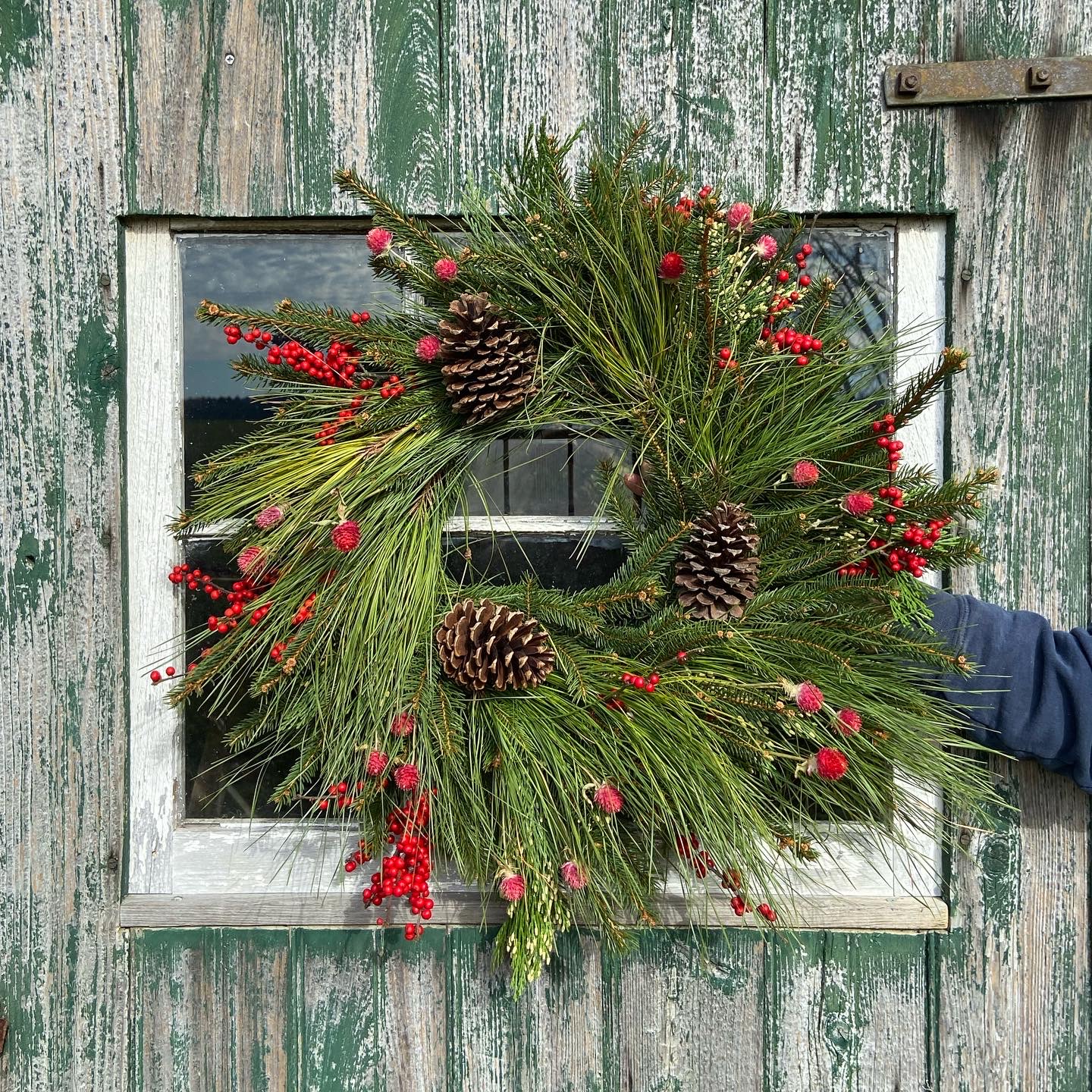 Christmas Wreath with pinecones and red berries