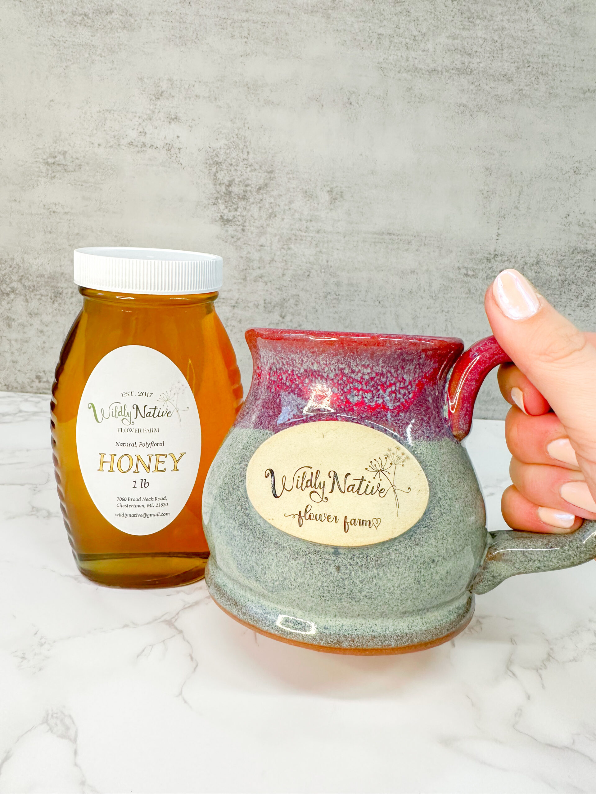 Hand Holding Stoneware mug with floral honey