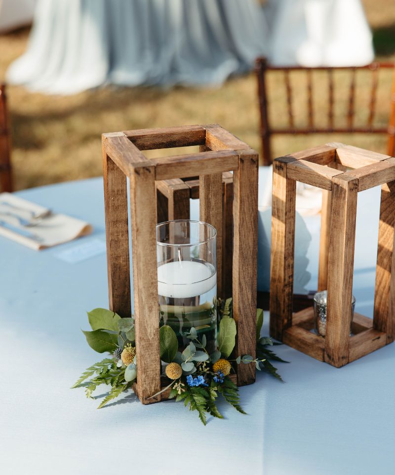 floating candles with greens and wooden boxes
