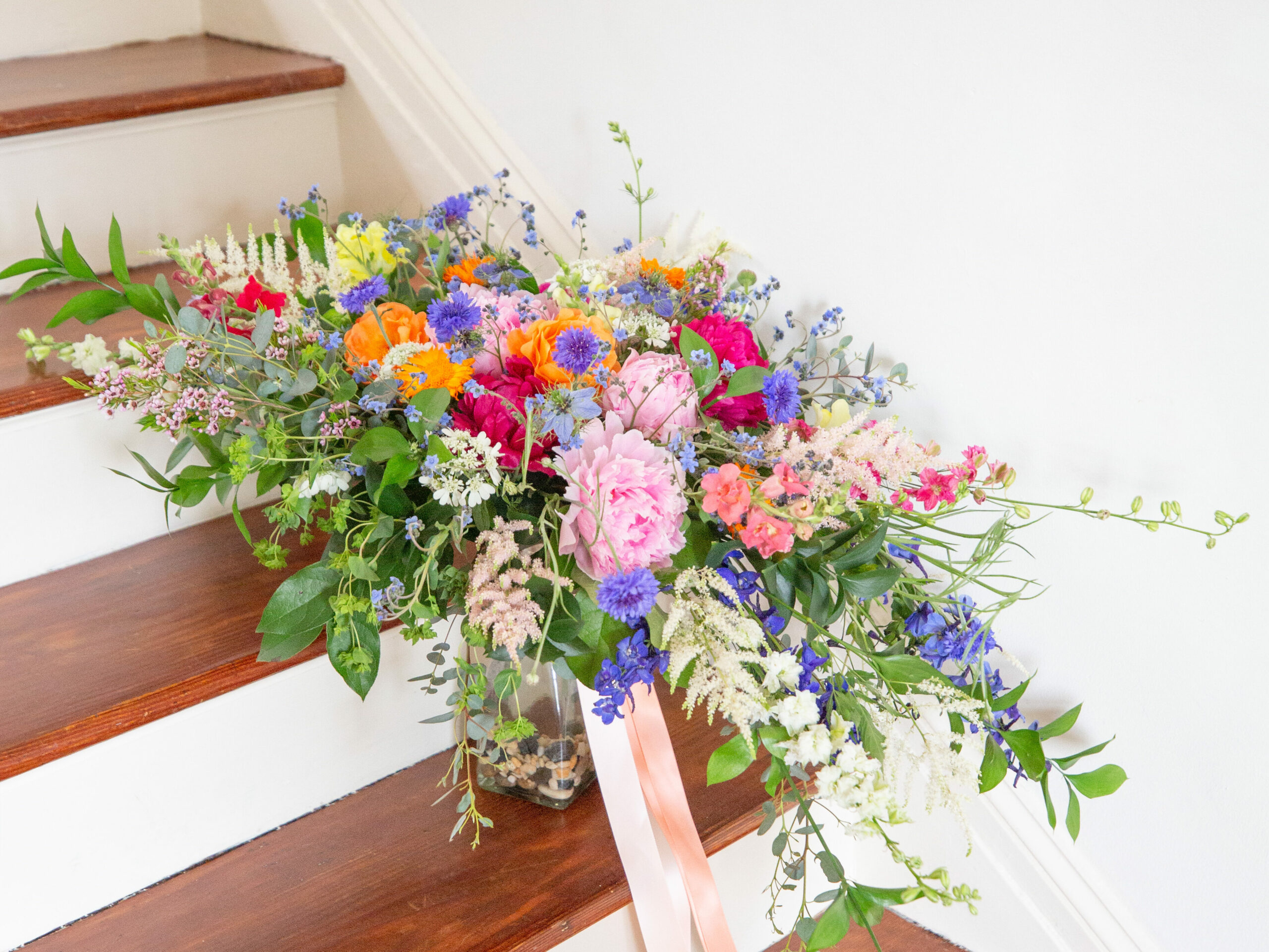Colorful wildflower bridal bouquet on stairs