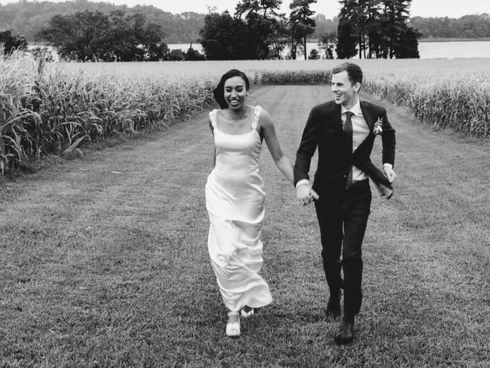 Bride and Groom at Brittland Estates walking through field