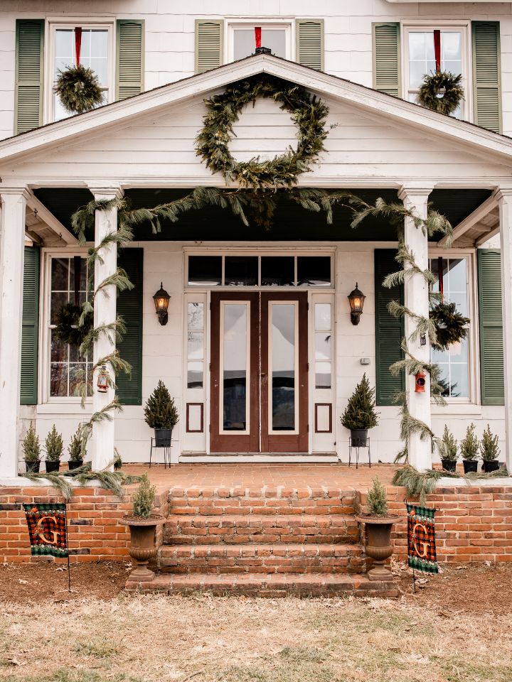 Private house with winter greenery on windows with wreaths