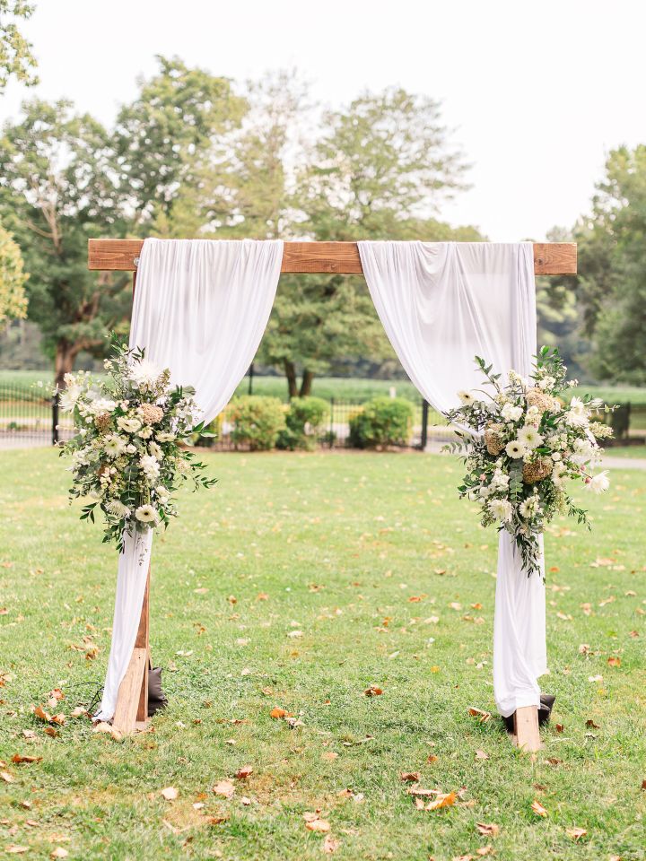 wooden arch with white fabric