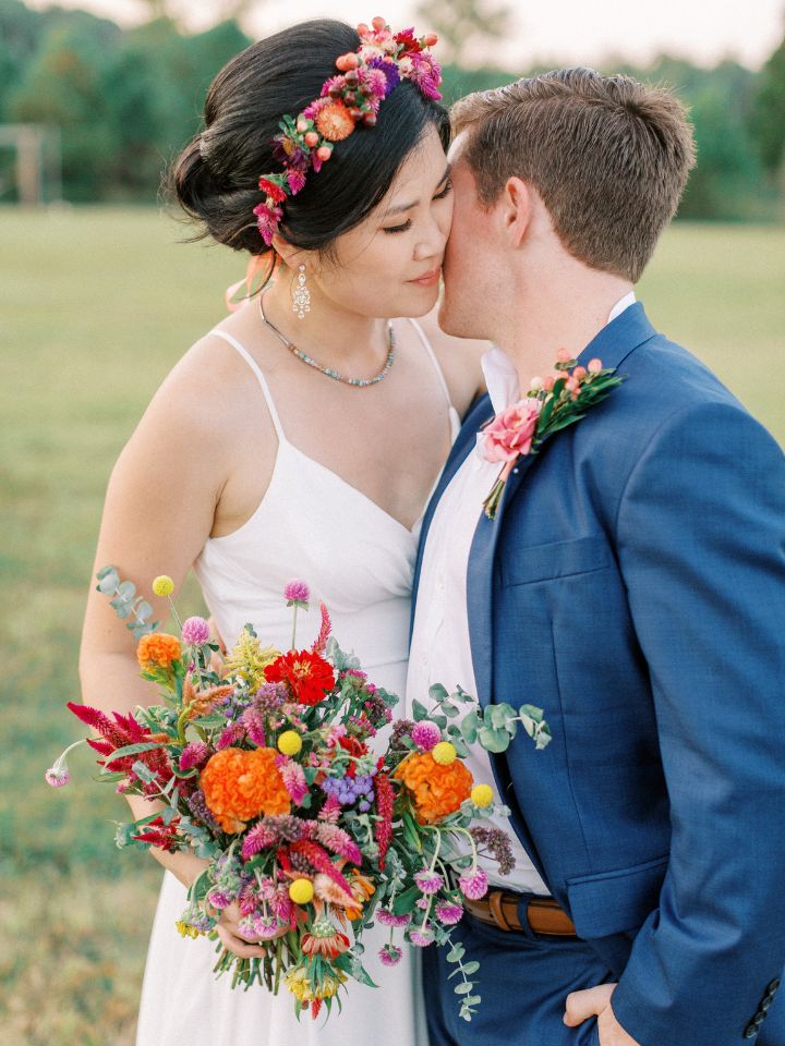 wildflower bouquet with bright oranges in the summer for petite bride