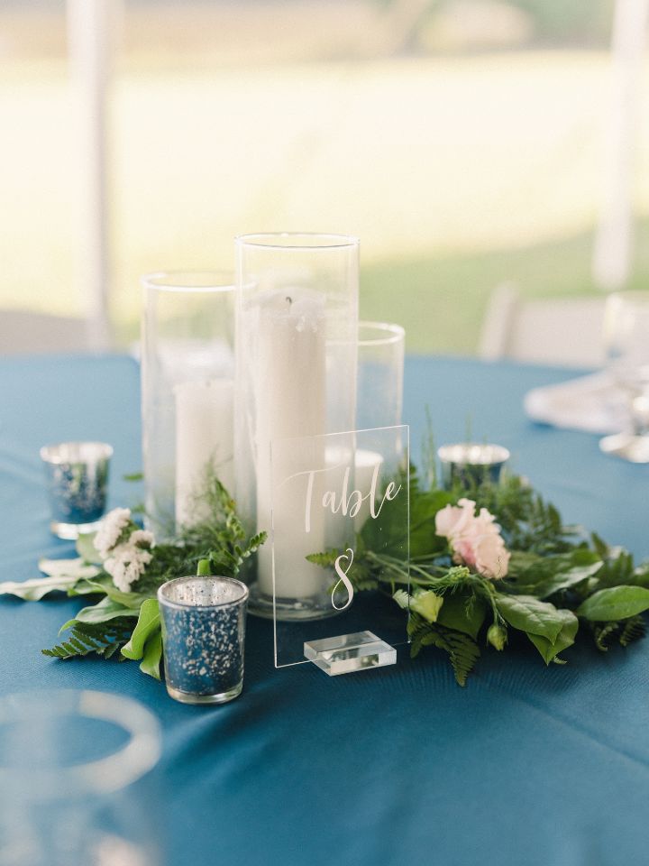 round wedding tables with greenery and pillar candles