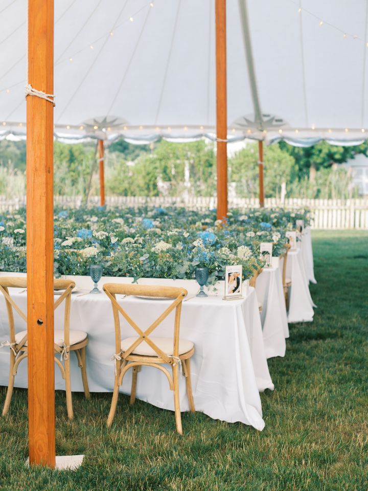 reception tables with white linens and blue and white box flowers