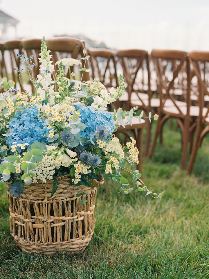 white and blue arrangements basket at the end of the aisle