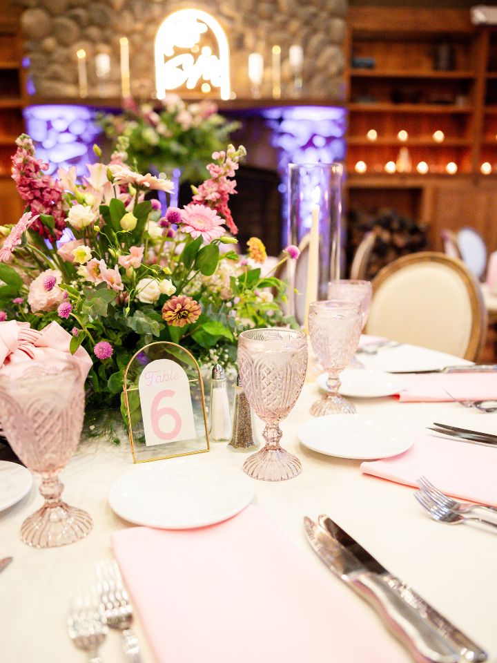 pink flowers and greenery with table setup