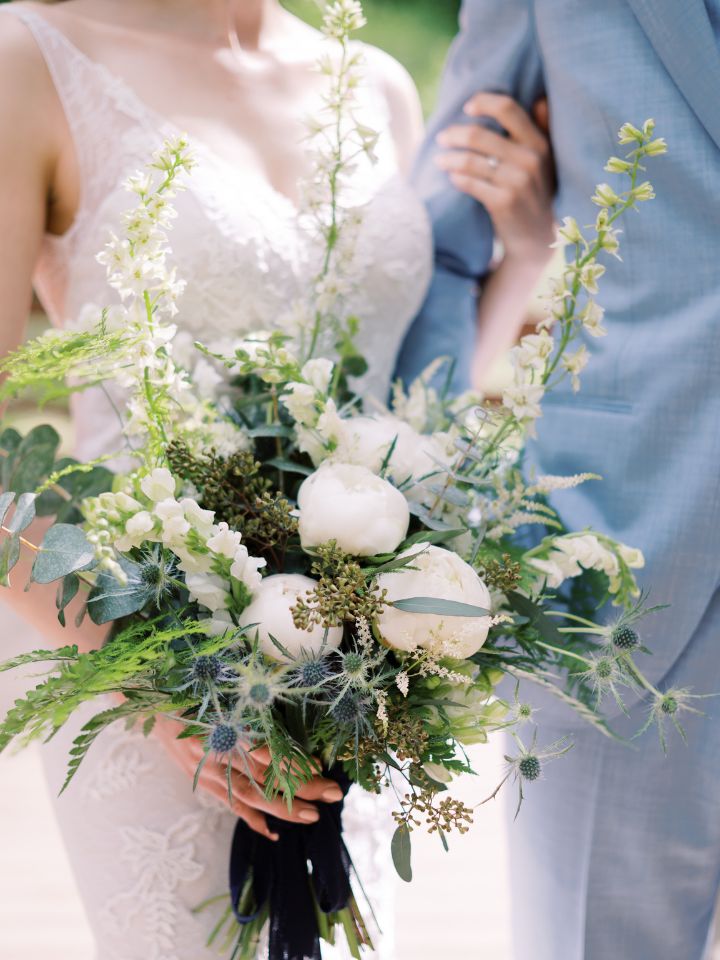 wedding bouquet with blue and white flowers one sided with greenery