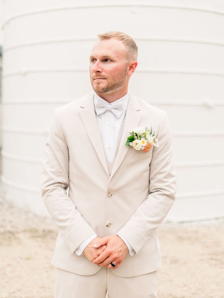 groom in beige suit with pocket square