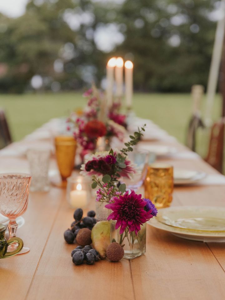 harvest tables with fruit and candles down the center of the table