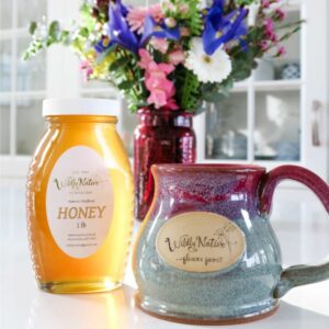 Stoneware mug with floral honey and fresh flower arrangement