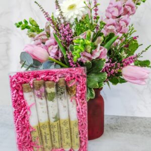 Bath Soak Sample Pack leaning up on a floral vase arrangement