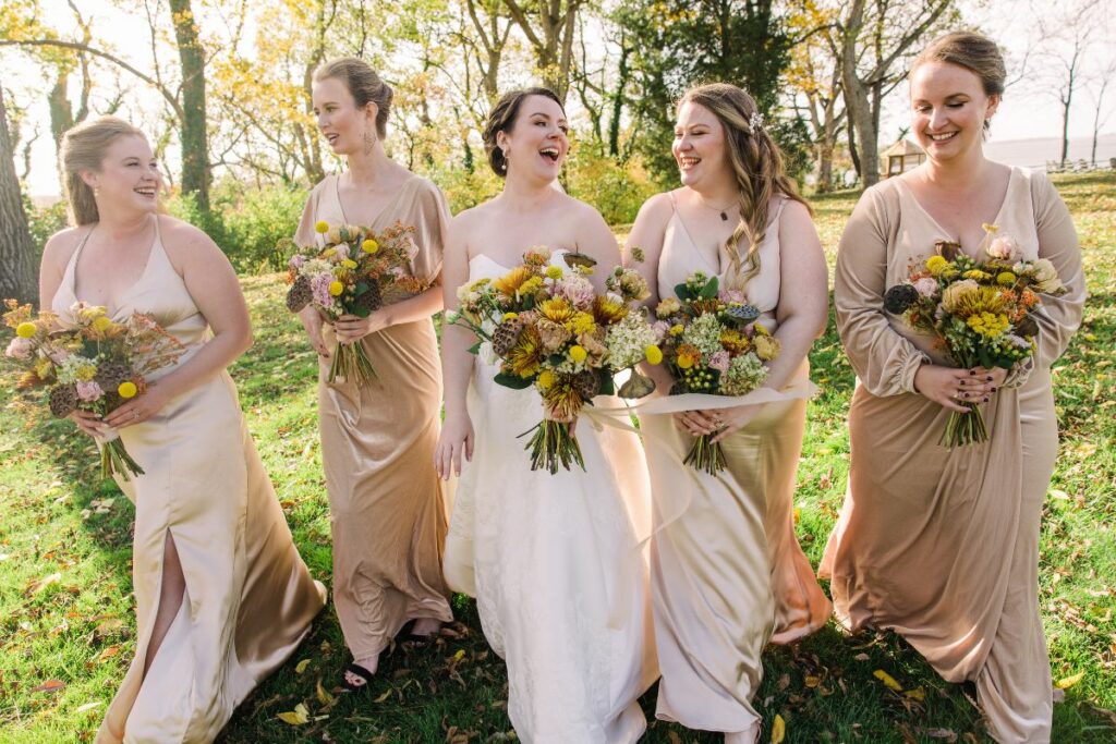 brides with her bridesmaids walking with her bouquet