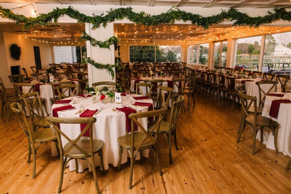 Ballroom at the Wylder Hotel is decorated for a Christmas wedding with evergreen garlands.