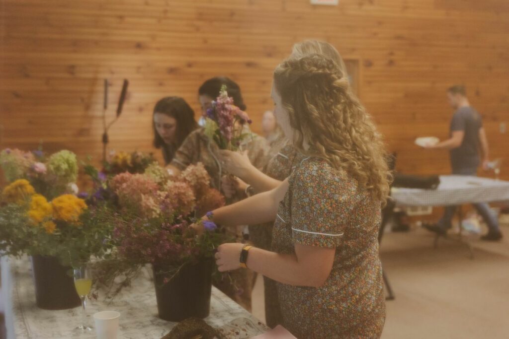 Bridesmaids making their own floral bouquets.