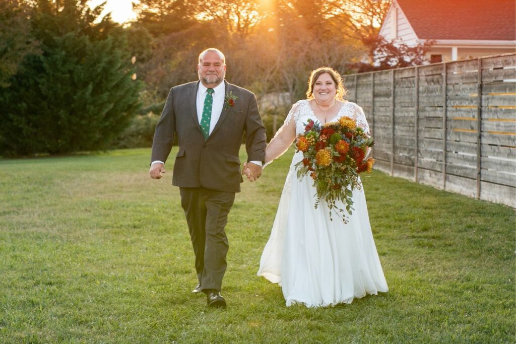 Bride walks down the aisle with her father and her bouquet.