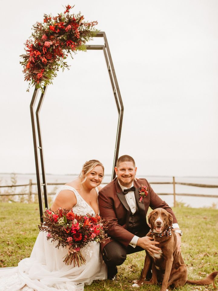 Bride and Groom with dog and moody jewel tone flowers.