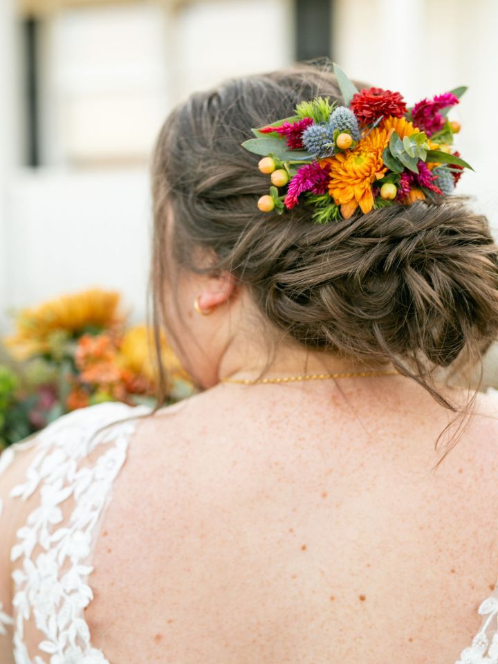 Close up of fall flower hair comb in a bridal updo.