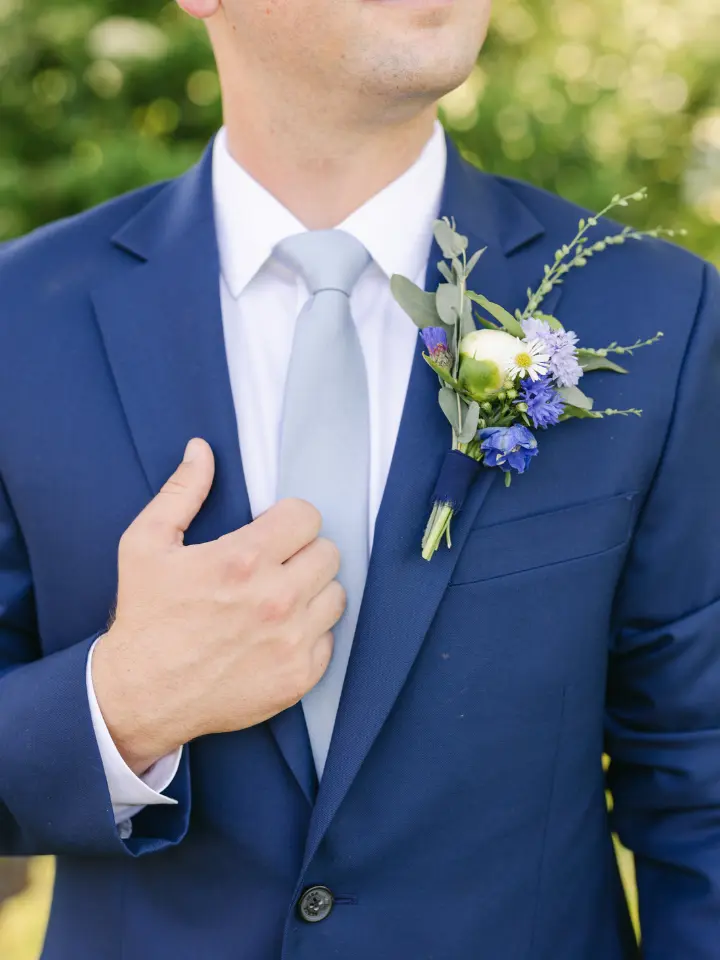 Blue Groom Suit up close with blue white and green boutonniere
