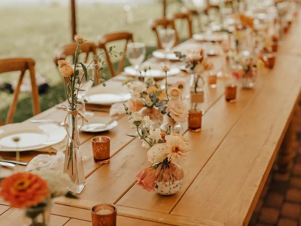 Wooden Harvest Table with candles and Bud Flower Arrangements
