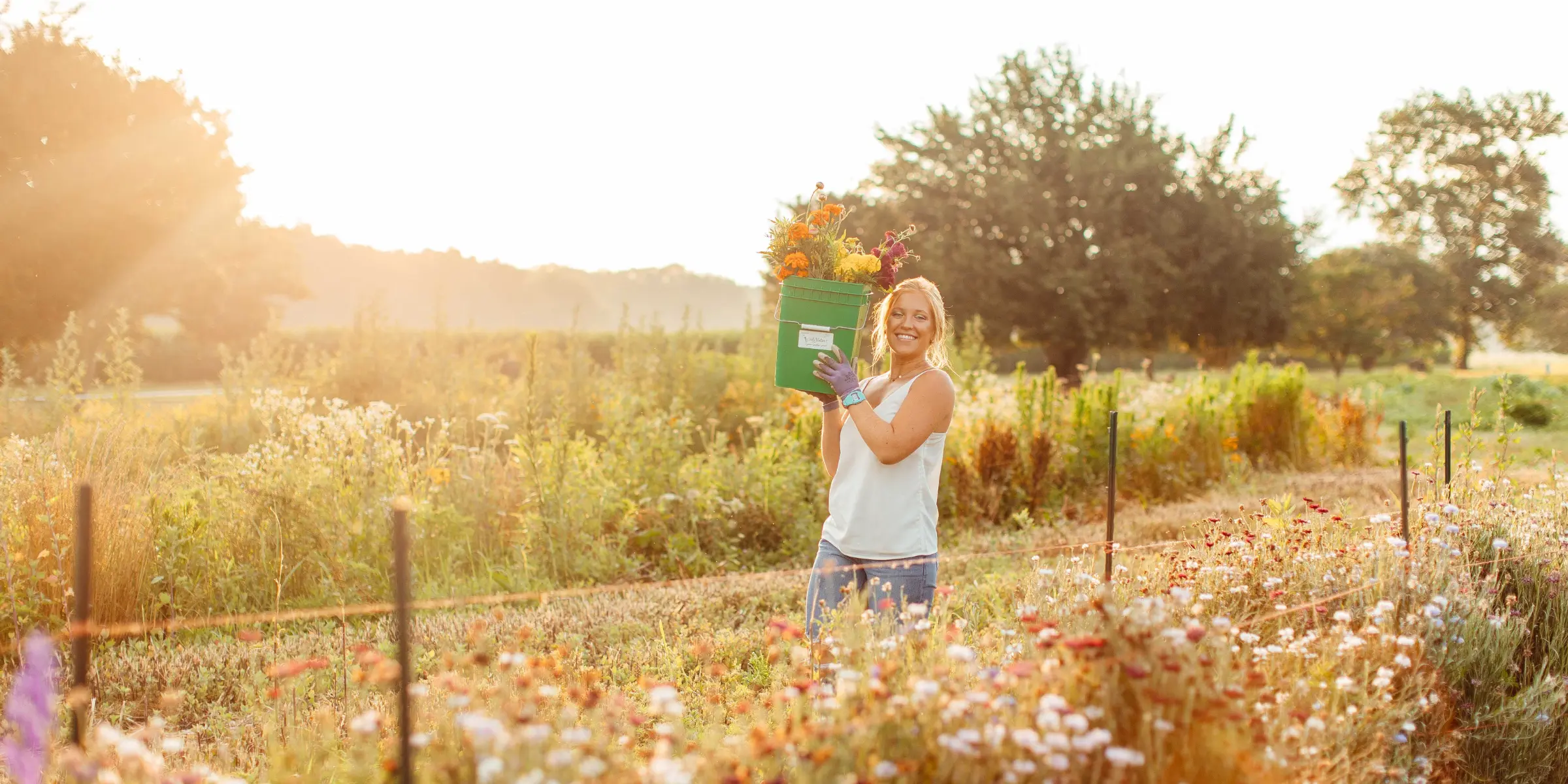 Lizzy holding a bucket in the flower fields