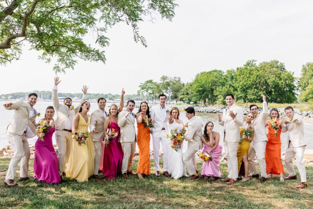 Wedding party lines up with groomsmen and bridesmaids on both sides of bride and groom.