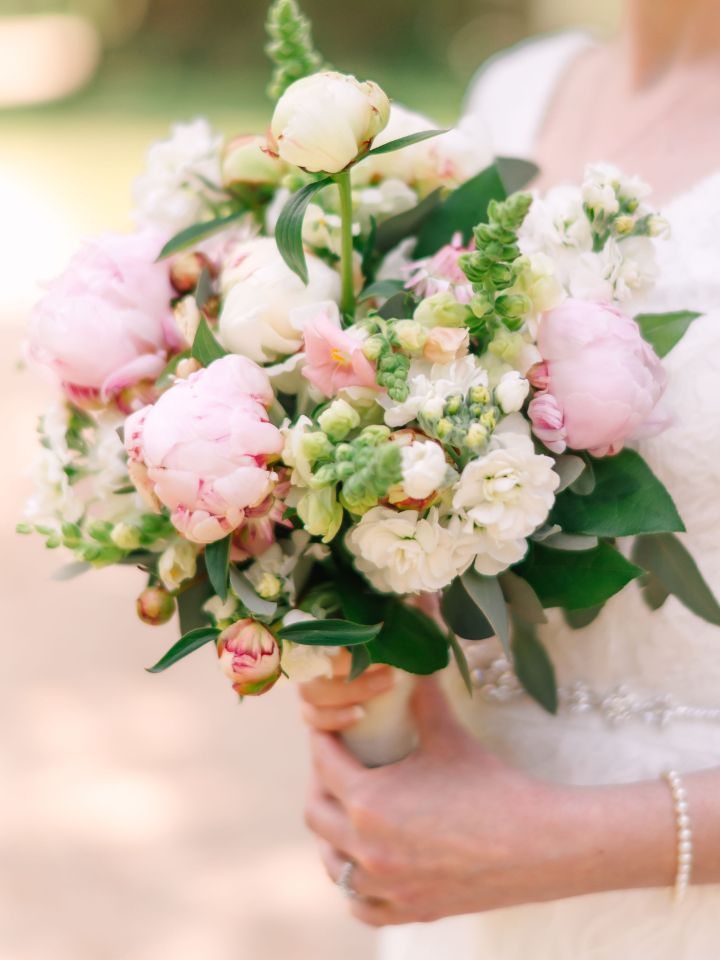 Bridal bouquet made of pink and white peonies and other spring flowers.