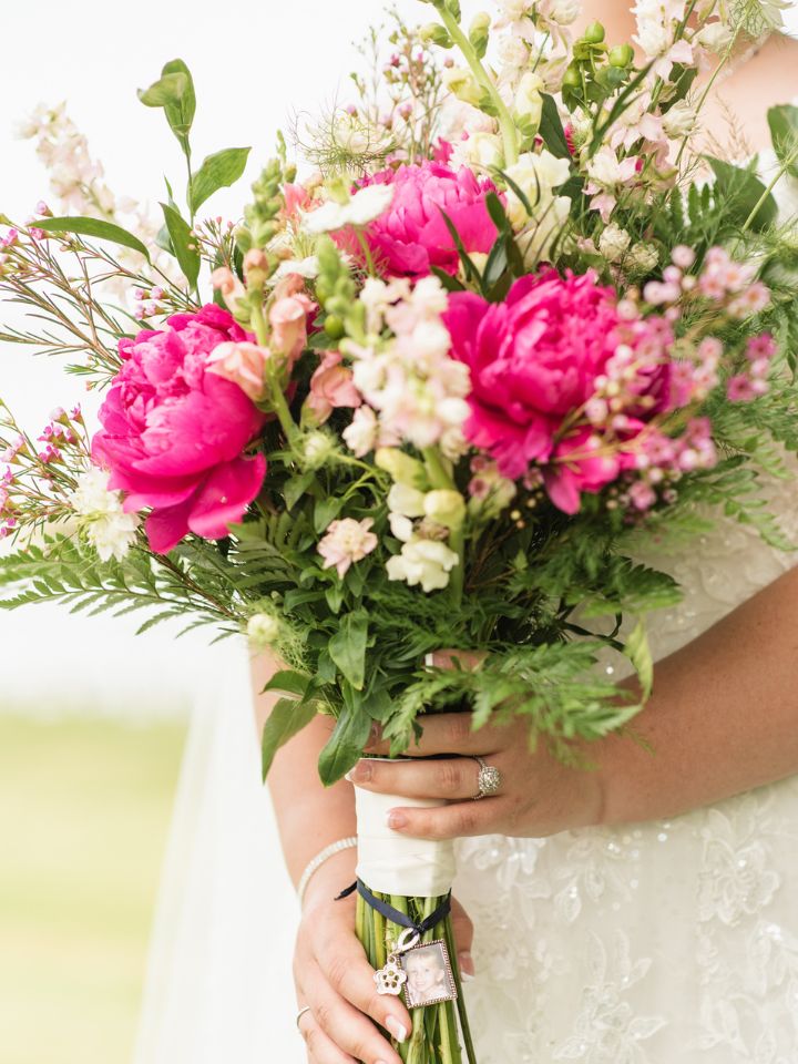 Close up of bridal bouquet with hot pink peonies.