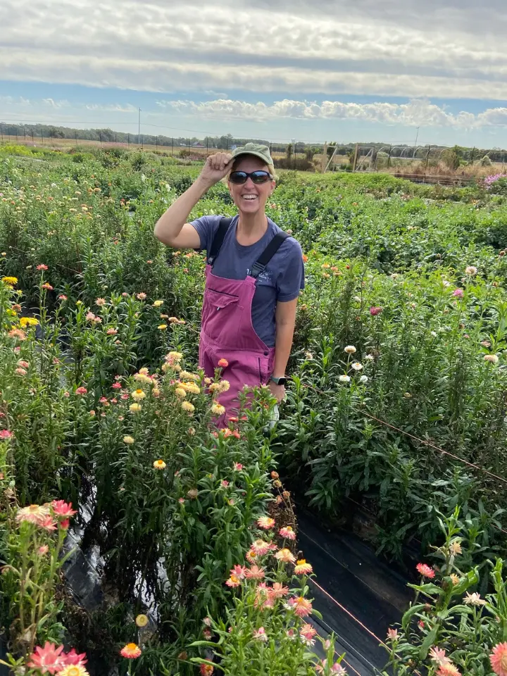 Farmer personality quiz result with Liza standing in the field in coveralls