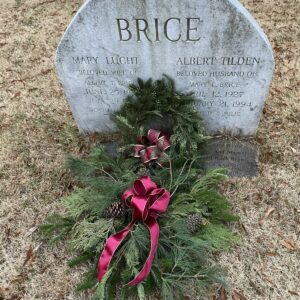 Gravestone with Christmas greenery.