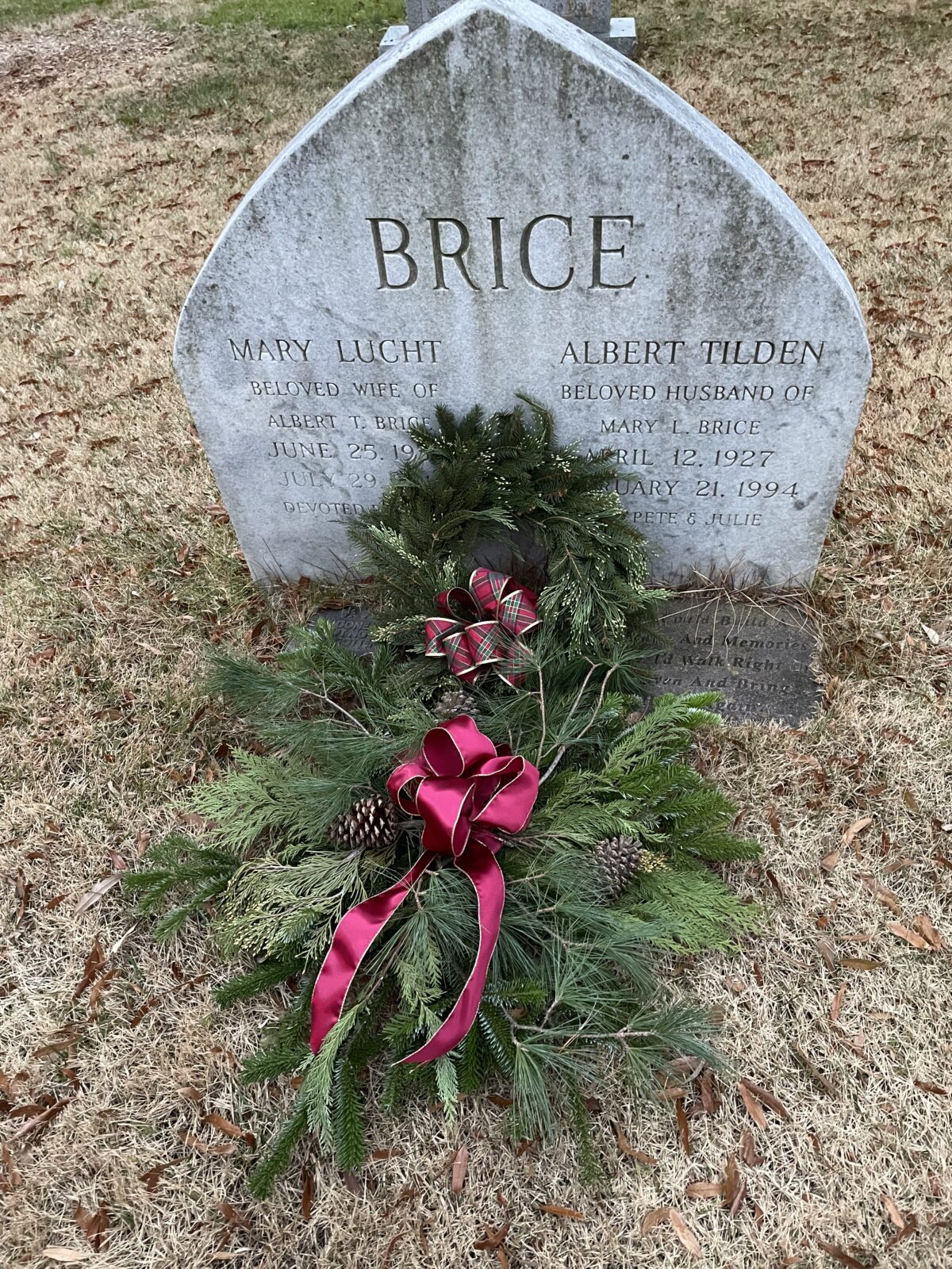 Gravestone with Christmas greenery.