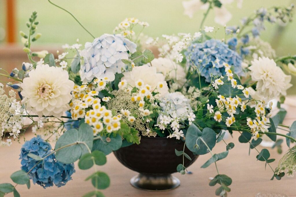 Copper compote centerpiece with hydrangea blue and white arrangmenet for wedding