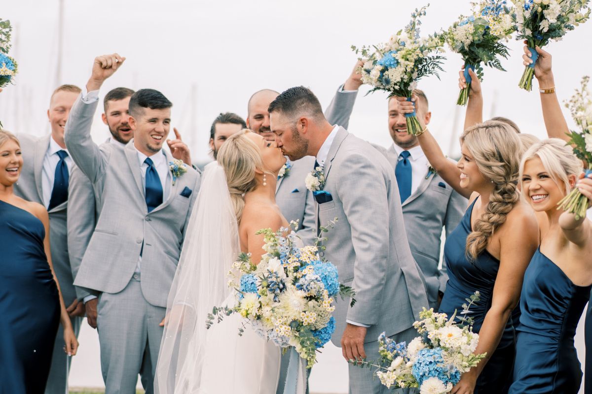 Bride and groom surrounded by cheering bridal party