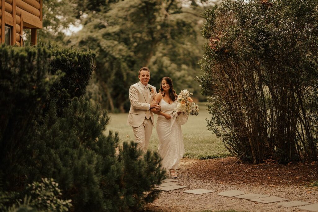 Bride and Groom hold hands and walk towards the camera