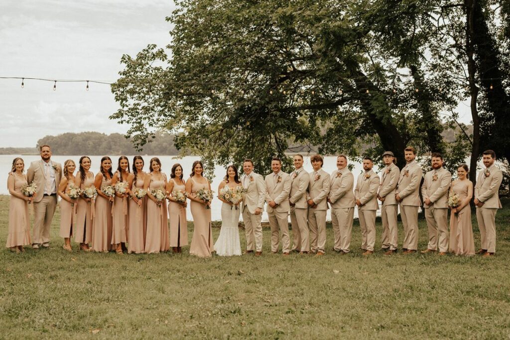 Bride and groom with bridal party by waterfront at Brittland Manor