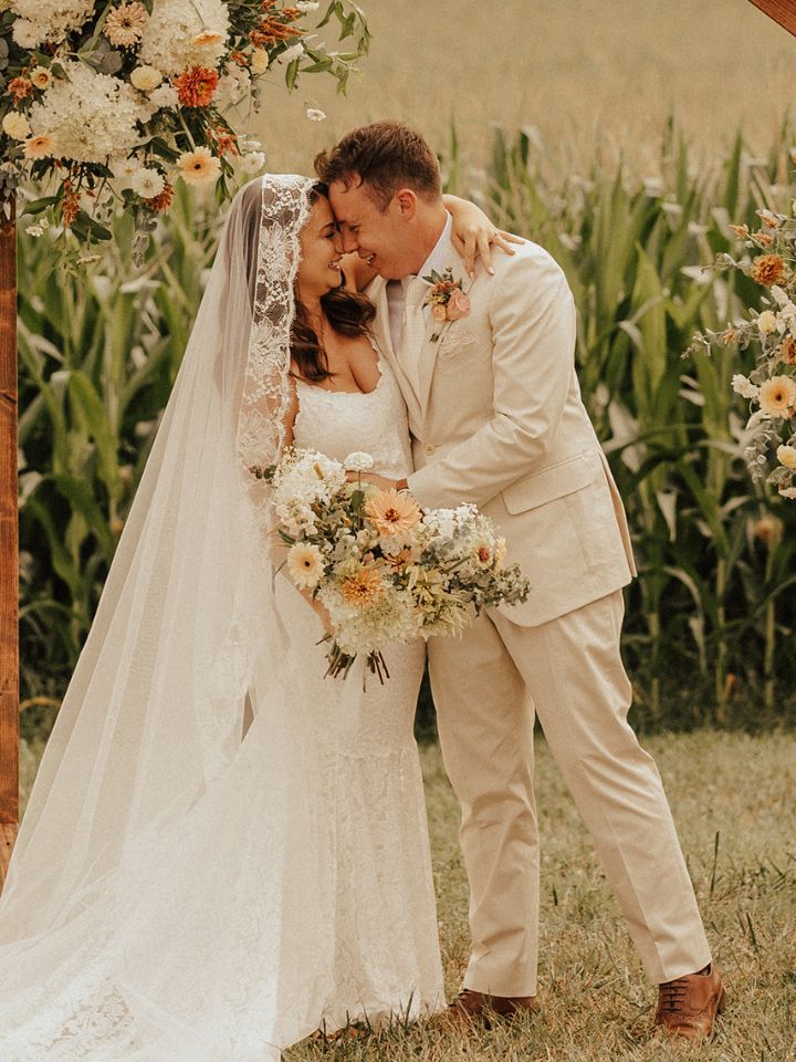 Bride and Groom hold each other in front of beautiful scenery of Brittland Manor