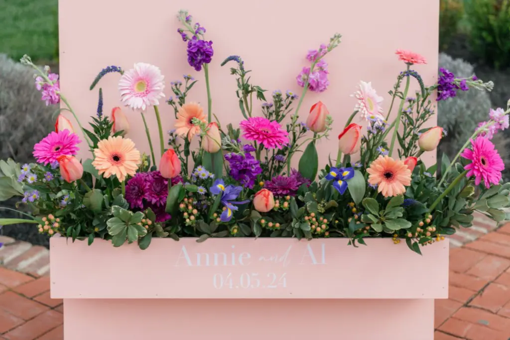 Close up of wedding sign flower box with "Annie and Al" written on it