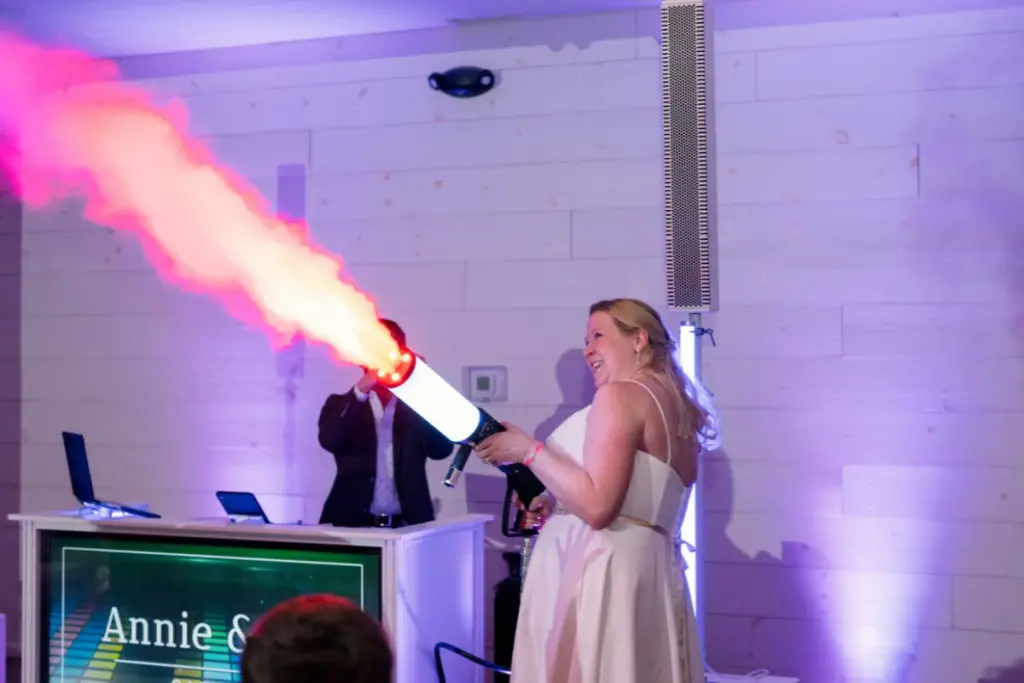 Bride using a flamethrower at unique wedding reception 