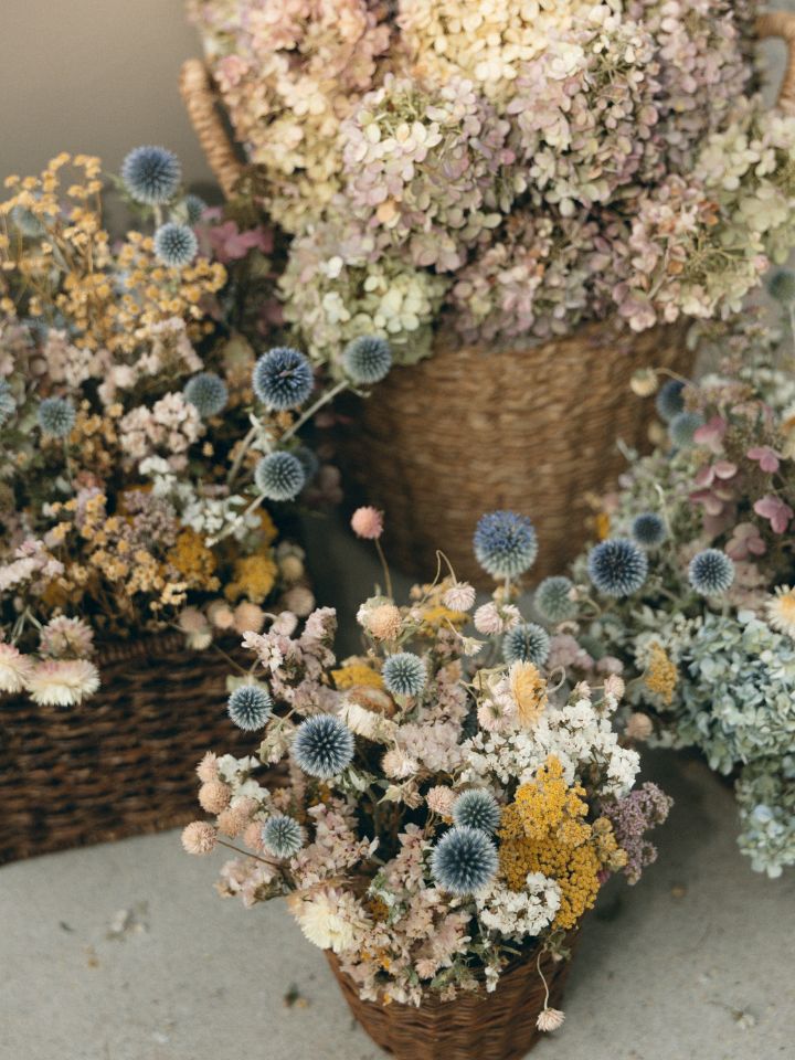 Dried Florals in soft colors, arranged in baskets.