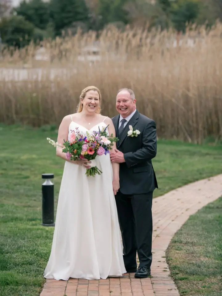 Bride and groom pose outside at Kent Island Resort for spring wedding