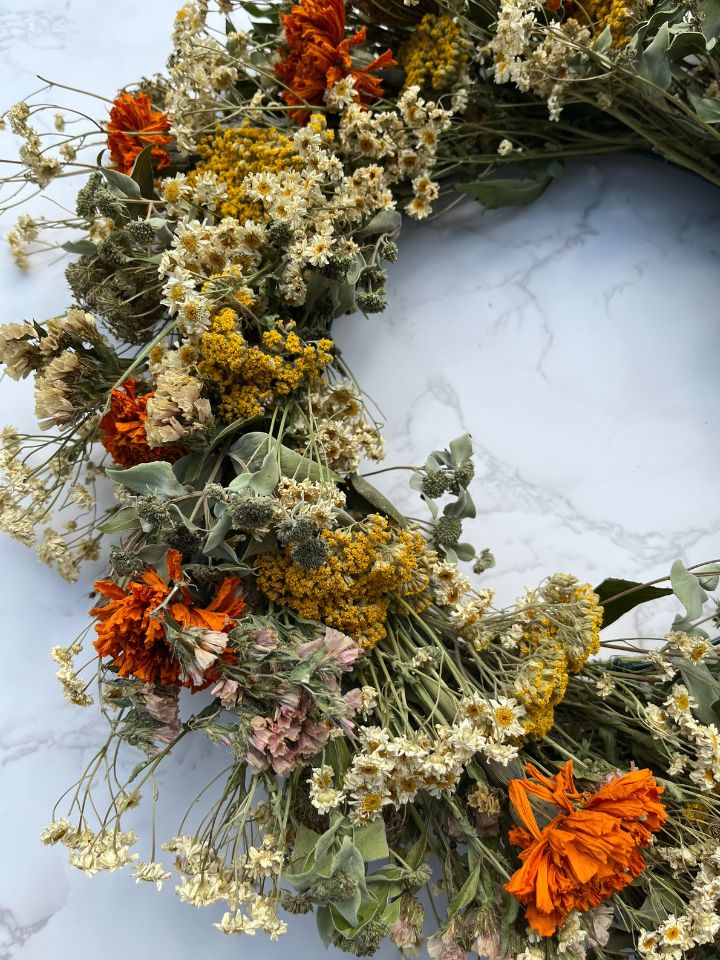 Closeup of dried flower wreath in harvest tones.