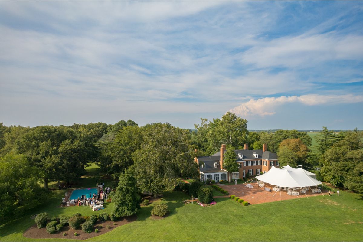 An overhead drone picture of Brittland Estates with a white tent set up.