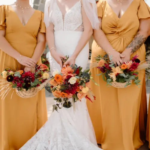 A bridal bouquet and basket bridesmaid bouquets up close