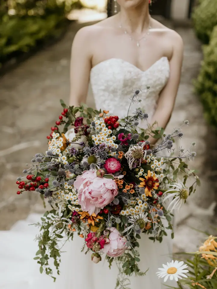 Showstopper bouquet with lots of greenery, pinks and red florals