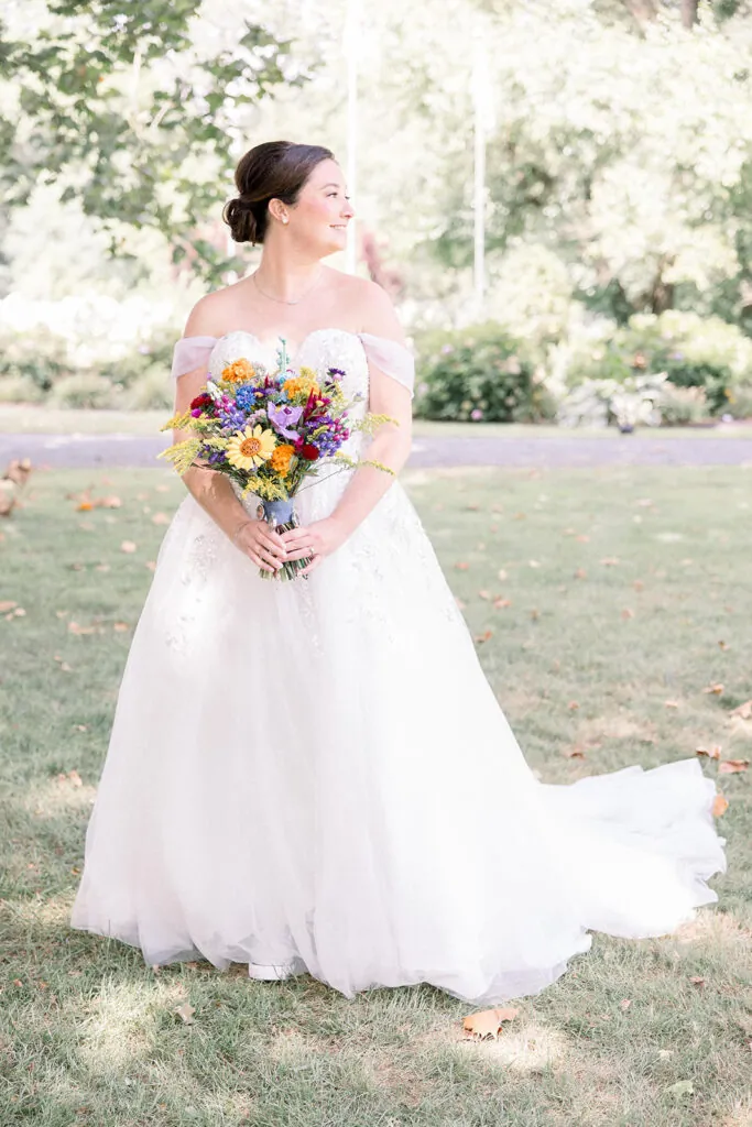 Bridal portrait at a summer wedding with brightly colored floral bouquet.