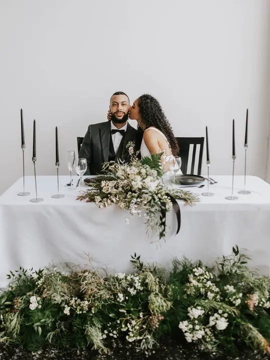 winter-sweetheart-install A winter sweetheart table setup with winter greenery at the base and on the table by Wildly Native Flower Farm